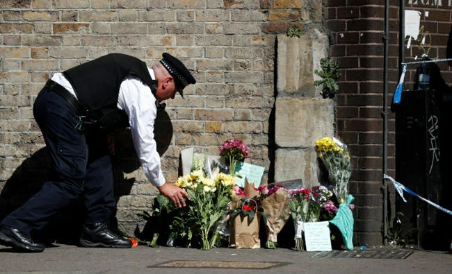 Floral tributes were left at the site where a vehicle was driven into Muslims worshippers near the Finsbury Park mosque in north London, on June 19, 2017. (AFP)