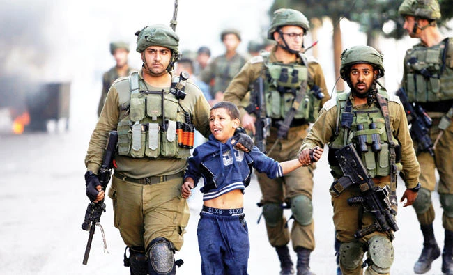 Israeli soldiers detain a Palestinian boy during recent clashes in the West Bank city of Hebron. (Reuters)