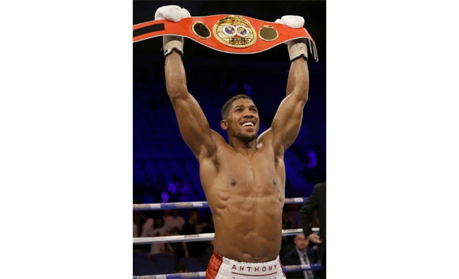Anthony Joshua lifts the belt he won in such spectacular fashion against Wladimir Klitschko at a sell-out Wembley Stadium. (Reuters)