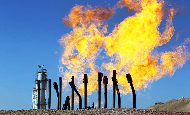 A photo taken on October 17, 2017 shows excess flammable gasses burning from gas flares at the Havana oil field, west of the multi-ethnic northern Iraqi city of Kirkuk. (AFP)
