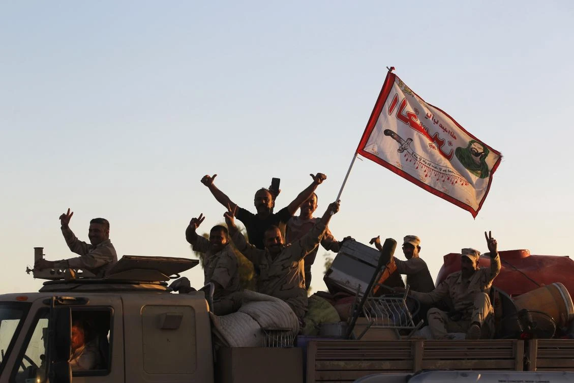Iraqi soldiers gesture on top of a vehicle as they enter the city of Kirkuk on October 17, 2017. Kurdish peshmerga forces withdrew without a fight after federal government troops and militia entered the city and seized the provincial governor’s office and key military bases. (AFP)