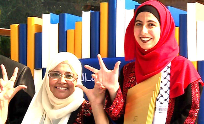 Palestinian high school student Afaf Raed Sharif, right, poses for a photo at the second annual Arab Reading Challenge
in Dubai. (AFP)