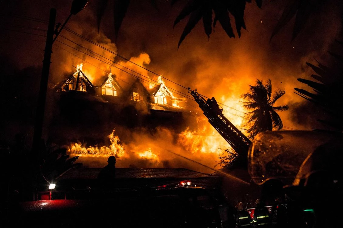 Above, firefighters work at the scene of a fire at Kandawgyi Palace hotel in Yangon early on October 19, 2017. (AFP)