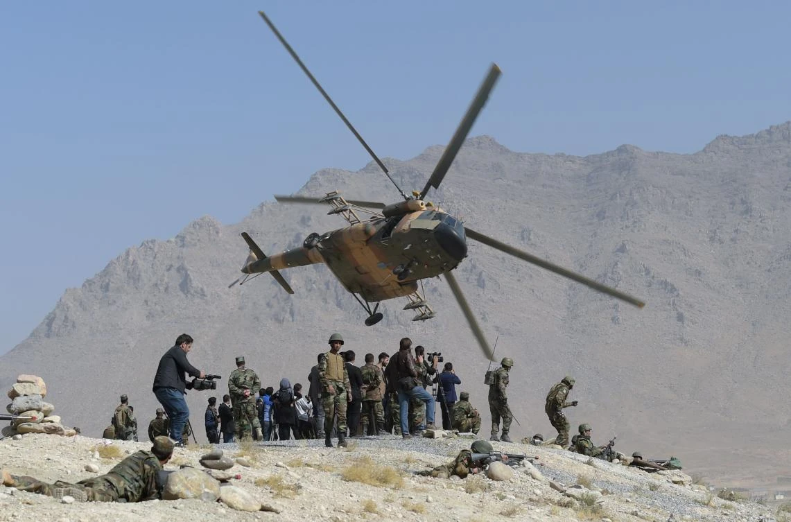 Above, an Afghan Air Force Mi-17 helicopter flies past commandos during a military exercise at the Kabul Military Training Center on the outskirts of Kabul on October 17, 2017. (AFP)