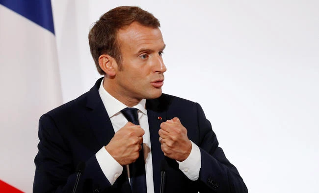 French President Emmanuel Macron delivers a speech at the Elysee Palace in Paris on Wednesday. (Reuters)