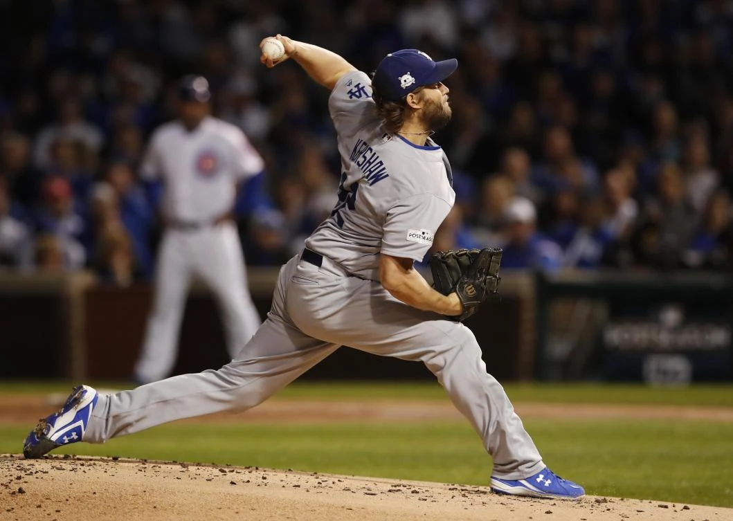Los Angeles Dodgers starting pitcher Clayton Kershaw throws a pitch against the Chicago Cubs in the first inning in game five of the 2017 NLCS playoff baseball series at Wrigley Field. (USA TODAY Sports)