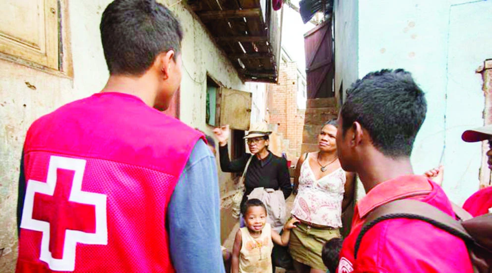 Red Cross volunteers talk to villagers about the plague outbreak, 30 miles west of Antananarivo, Madagascar, on Monday. (AP)