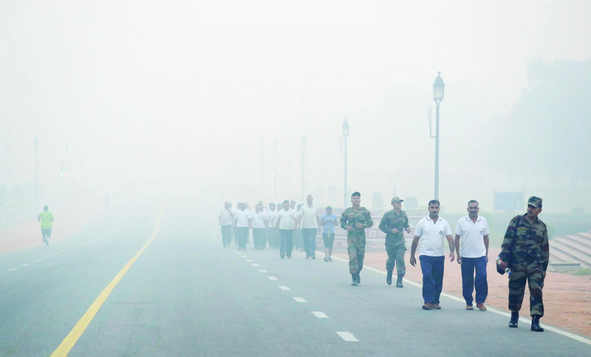 Indian soldiers walk amidst morning smog in New Delhi, on Friday. (AP)