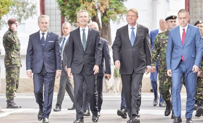 NATO Secretary-General Jens Stoltenberg and Romanian President Klaus Iohannis arrive to review NATO multinational brigade in Craiova, Romania, in this October 9, 2017 photo. (Reuters)