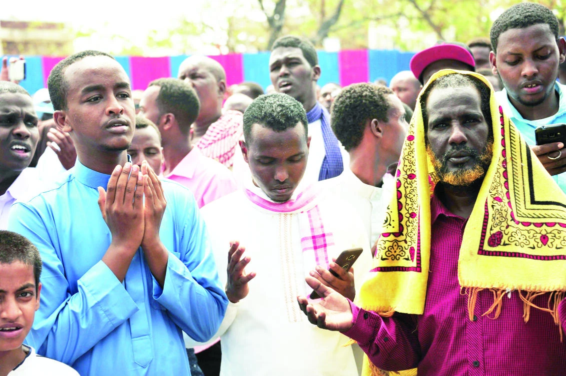 Somalis pray for victims at the scene of last Saturday’s massive truck bomb attack in Mogadishu. (AFP)