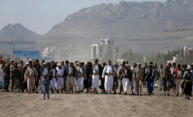 A child (front) joins members of the Shi'ite Houthi movement celebrating during an occasion in Sanaa, Yemen, on September 9, 2017. Houthi's youth minister has proposed using child soldiers in the country’s ongoing civil war. (REUTERS/Khaled Abdullah)