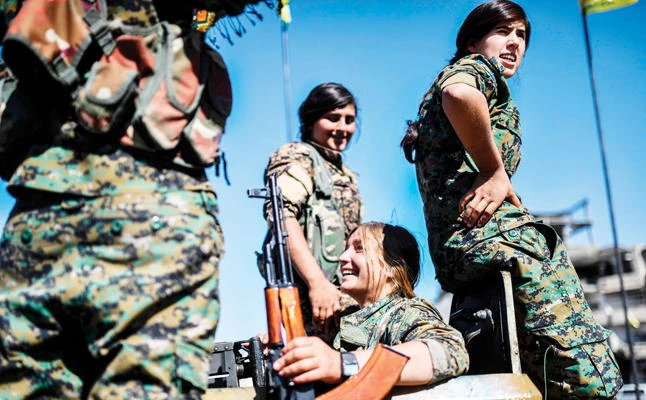 Female Kurdish fighters of the Syrian Democratic Forces (SDF) gather during a celebration at the iconic Al-Naim Square in Raqqa after retaking the city from Daesh fighters. (AFP)