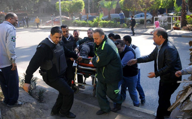 In this December 9, 2016 file photo, Egyptian emergency services carry a wounded victim at the site of a bomb attack next to a police checkpoint in Talibiya district of Cairo. On Friday, at least 35 soldiers and policemen were killed in another terror attack in Egypt. (AFP file photo)