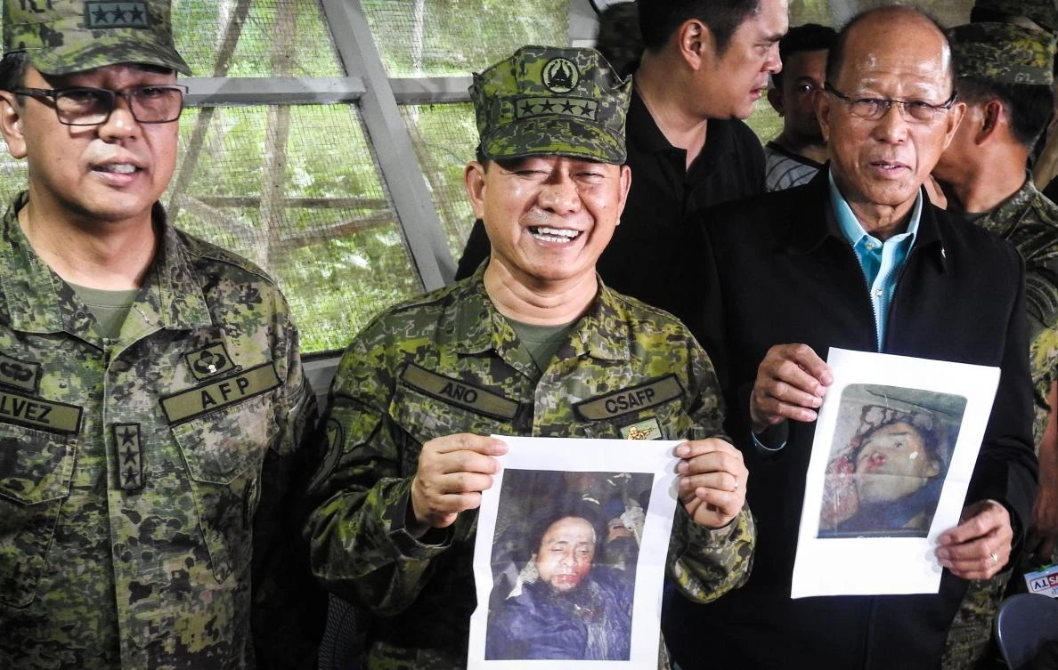 Philippine military chief General Eduardo Ano (C) holds an image of militant leader Isnilon Hapilon, next to Defence Secretary Delfin Lorenzana (R) showing an image of Omarkhayam Maute, and Western Mindanao Commanding General Carlito Galvez (L) during a press conference at a military camp in Marawi on the southern island of Mindanao on October 16, 2017. (AFP)