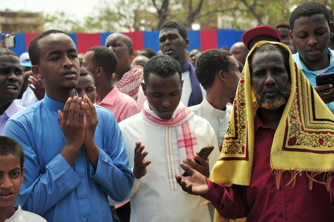 Somalis pray for victims on October 20, 2017 in Mogadishu on the scene of a massive truck bomb attack. (AFP)
