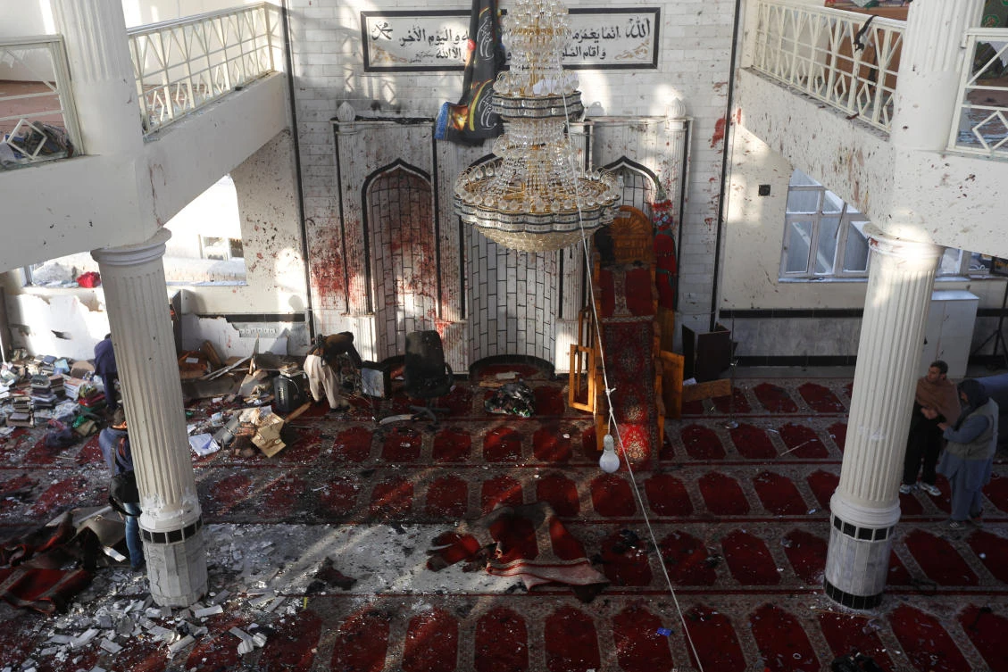 Men inspect inside a Shiite Muslim mosque after last night attack in Kabul. (Reuters)