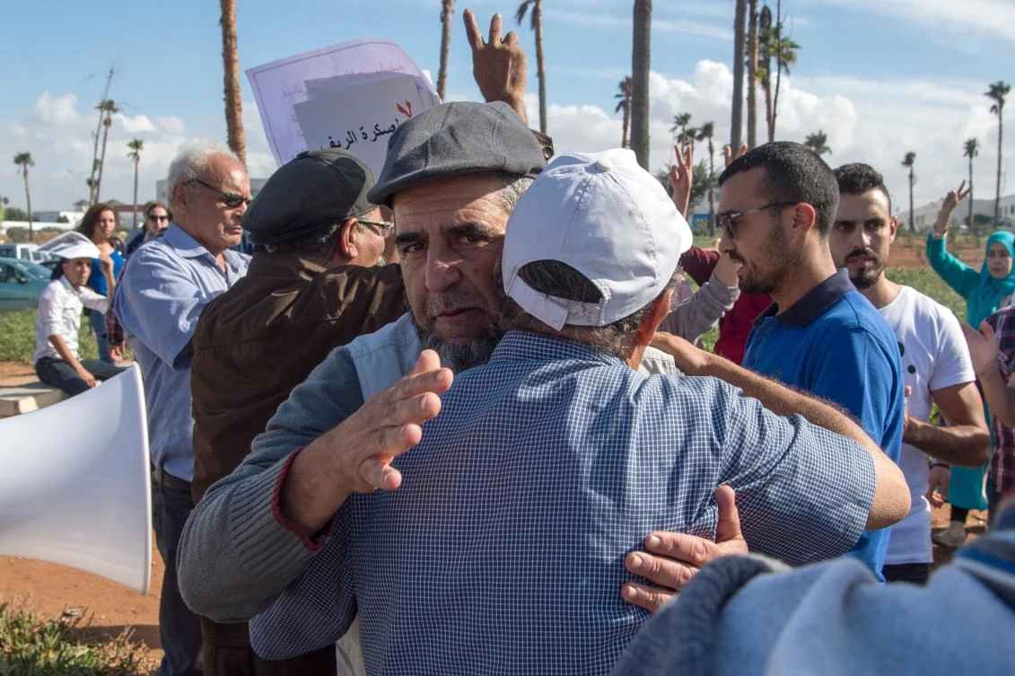 Relatives of imprisoned members of Morocco’s Al-Hirak Al-Shaabi movement hug each other after visiting the detainees at the Oukacha prison in Casablanca on October 18. (AFP)