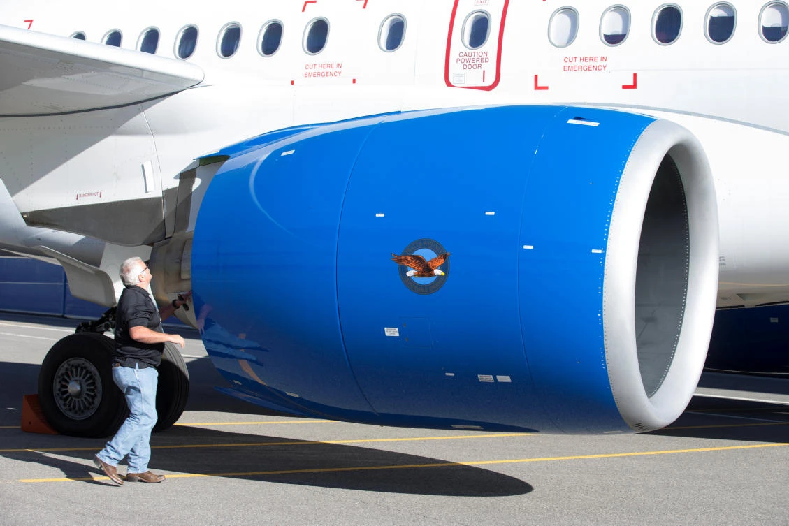 Above, an employee inspects the engine of a C Series plane at Bombardier’s plant in Canada. (Reuters)