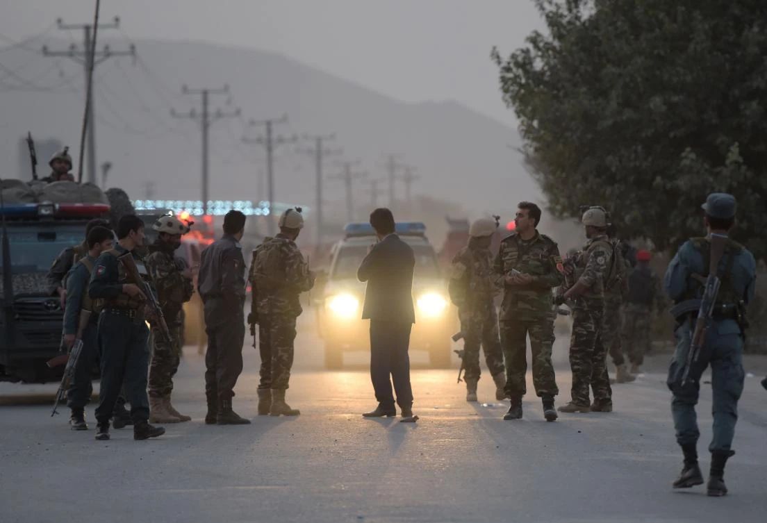 Above, Afghan security personnel gather as they keep watch near the site of a suicide bomb attack near the Marshal Fahim military academy base in Kabul. (AFP)