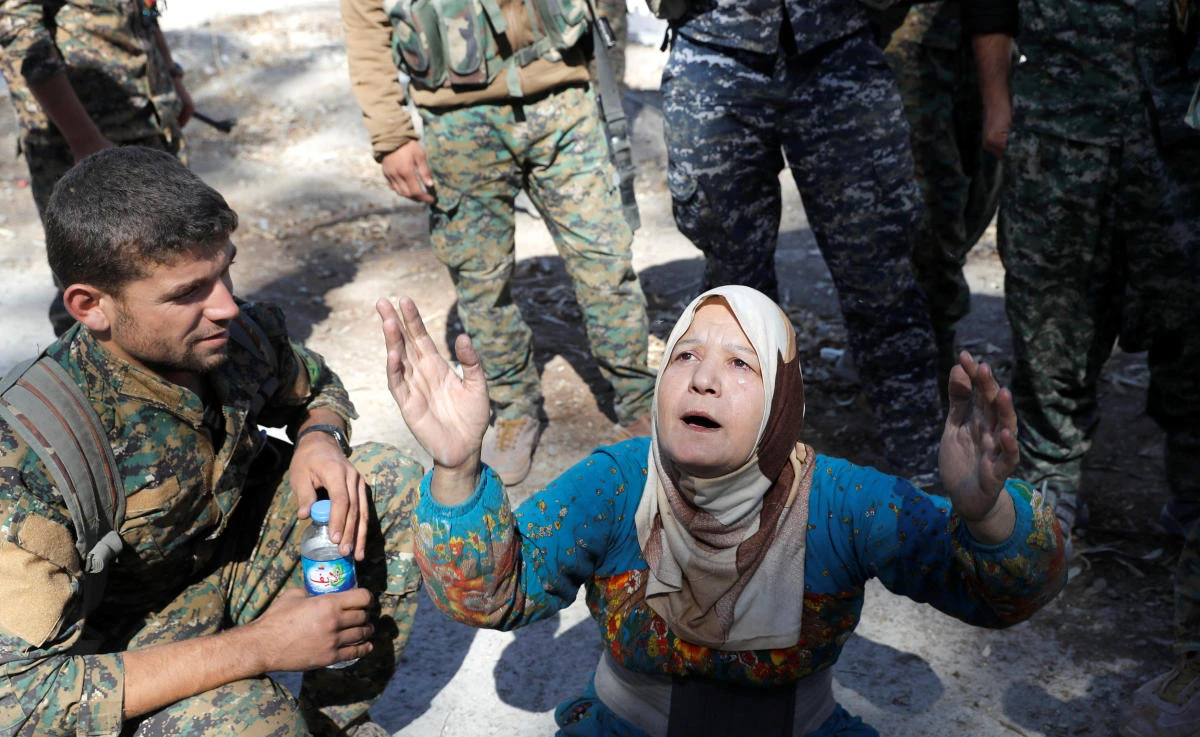 A civilian prays after she was rescued by fighters of Syrian Democratic Forces from the stadium after Raqqa was liberated from the Daesh militants in Raqqa. (Reuters)