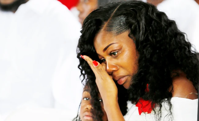 Myeshia Johnson, widow of U.S. Army Sergeant La David Johnson, who was among four special forces soldiers killed in Niger, sits with her daughter, Ah'Leeysa Johnson at a graveside service in Hollywood, Florida, on Saturday. (REUTERS)