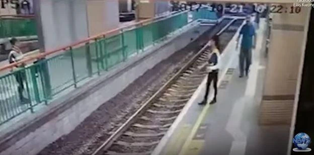 The woman can be seen walking along the platform, her attacker behind her (YouTube)