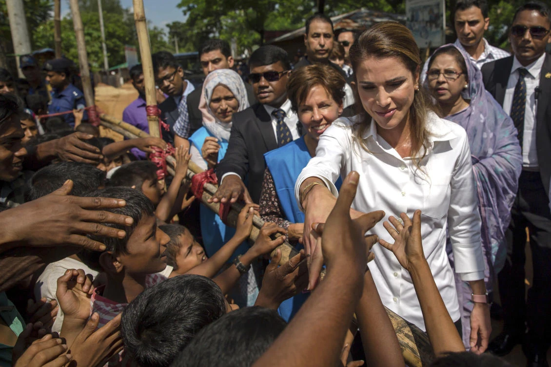 Queen Rania of Jordan shakes hands with Rohingya Muslim children, who have crossed over from Myanmar into Bangladesh, during her visit to Kutupalong refugee camp, Bangladesh, Monday, Oct. 23, 2017. Nearly 600,000 Rohingya Muslims have fled Myanmar's Rakhine state since Aug. 25 to escape persecution that the United Nations has called ethnic cleansing. (AP Photo/Dar Yasin)