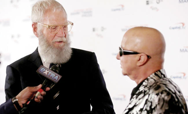 Comedian David Letterman and his band leader Paul Shaffer speak to the media as Letterman arrives for a gala where he is receiving the Mark Twain Prize for American Humor at Kennedy Center in Washington Monday. (Reuters)