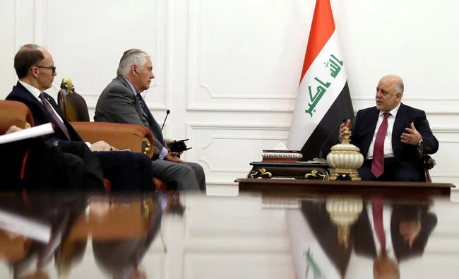 US Secretary of State Rex Tillerson, second from left, listens as Iraqi Prime Minister Haider Al-Abadi, right, speaks during their meeting in Baghdad on Monday. (Reuters)