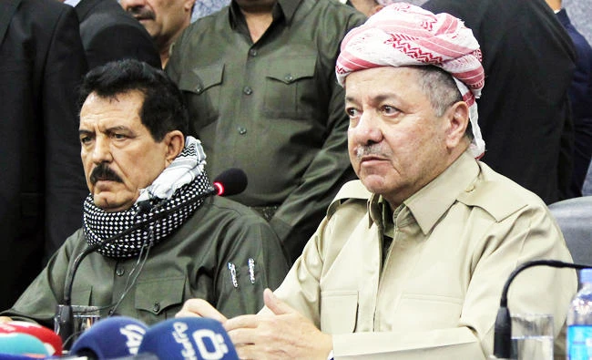 A file photo taken on September 12, 2017 shows Iraq's Kurdistan region president Massud Barzani (R) attending an assembly with Kosrat Rasoul Ali (L), the first Deputy for the Secretary General of the Patriotic Union of Kurdistan (PUK) party, and other representatives of the Peshmerga and Arab, Kurdish, and Iraqi Turkmen tribal leaders in the northern Iraqi city of Kirkuk. (AFP)