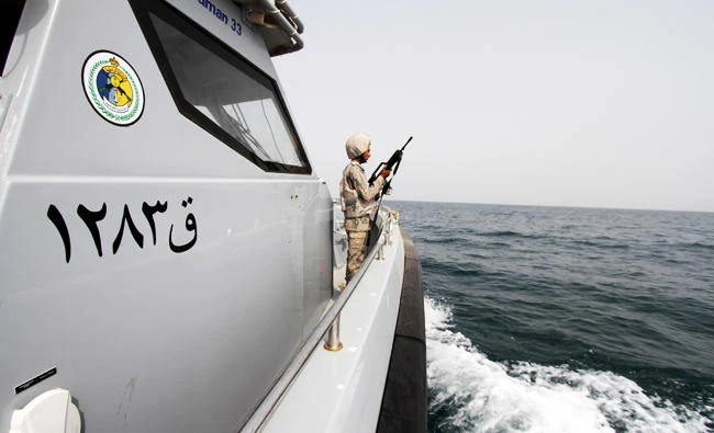 A Saudi border guard watches as he stands in a boat off the coast of the Red Sea on Saudi Arabia's maritime border with Yemen, near Jizan, in this April 8, 2015 file photo. (Reuters)