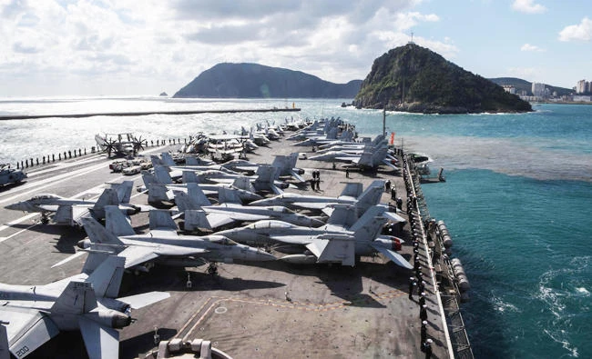 This US navy photo obtained October 22, 2017 shows the forward-deployed aircraft carrier, USS Ronald Reagan (CVN 76), as it maneuvers along the coast prior to a scheduled port visit in Busan, Republic of Korea on October 21, 2017. (AFP)