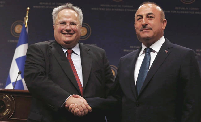 Turkey's Foreign Minister Mevlut Cavusoglu, right, and Greek Foreign Minister Nikos Kotzias shake hands after a joint news conference in Ankara, Turkey, on Tuesday.(AP)
