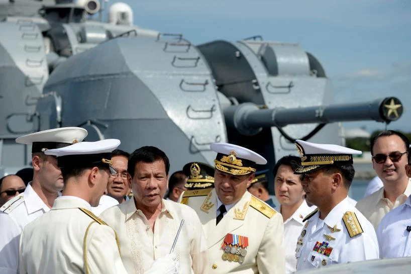 Philippine President Rodrigo Duterte, third left, talks to Russia’s Rear Admiral Eduard Mikhailov, fourth left, while aboard the Admiral Tributs, one of Russian warships there were a four-day visit to Manila in January. (Reuters)