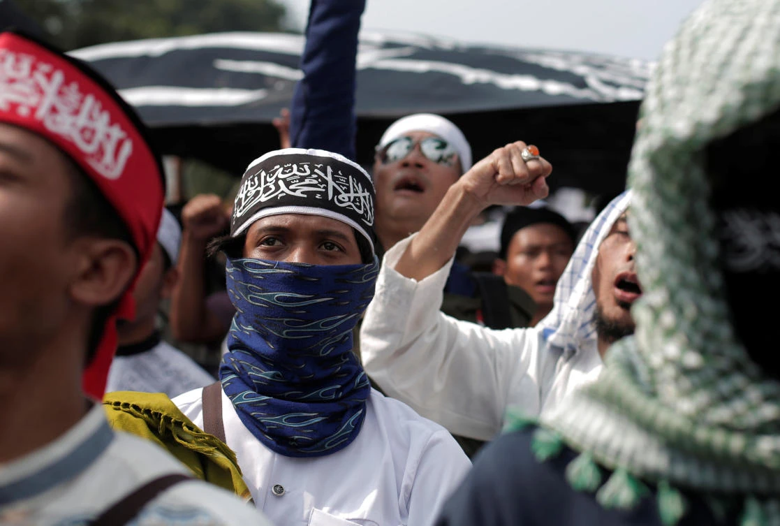 Protesters shout slogans during a protest against Indonesian President Joko Widodo’s decree to disband Islamist groups, which lawmakers approved on Tuesday, October 24. (Reuters)