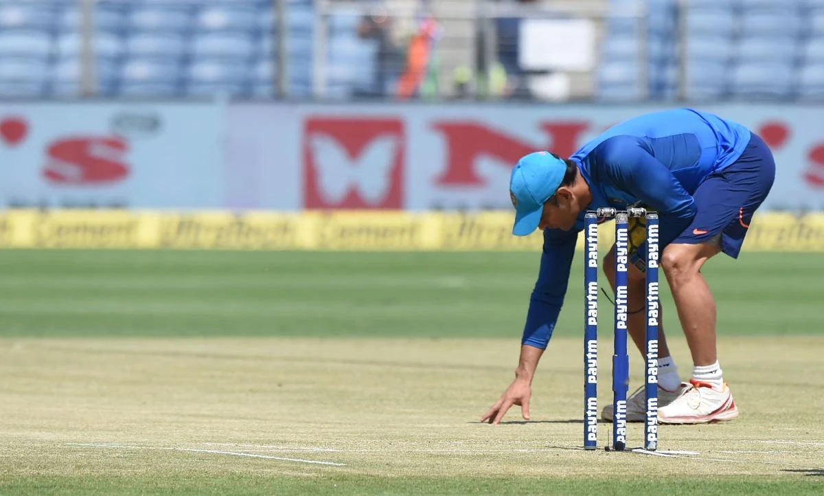Indian cricketer Mahendra Singh Dhoni inspects the pitch ahead of the 2nd one day international (ODI) cricket match between India and New Zealand at The Maharashtra Cricket Association Stadium in Pune on October 25, 2017. (AFP)