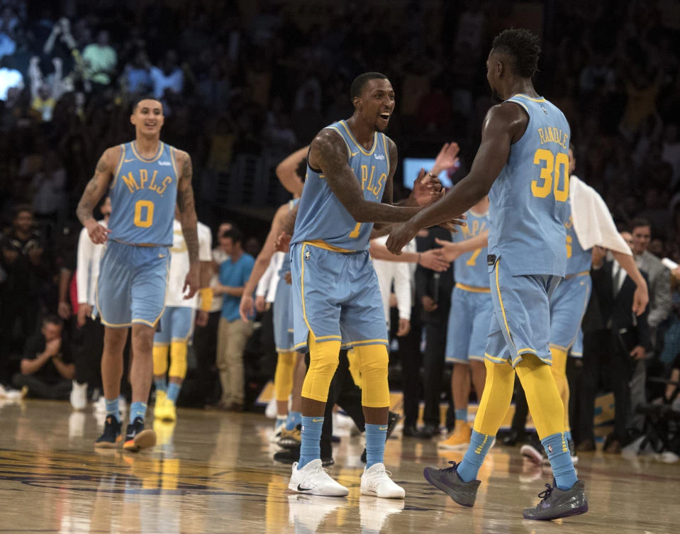Los Angeles Lakers guard Kentavious Caldwell-Pope, center, and Los Angeles Lakers forward Julius Randle, right, celebrate Randle’s dunk during the second half of an NBA basketball game against the Washington Wizards in Los Angeles, Wednesday, Oct. 25, 2017. The Lakers won, 102-99. (AP/Kyusung Gong)