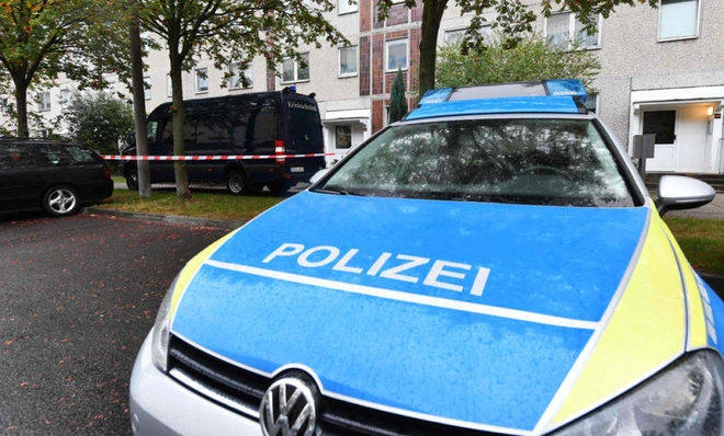 A police vehicle and a vehicle of the criminal technology park in front of the access to an house in the district of Paunsdorf in Leipzig, eastern Germany on Monday, October 10, 2016. (File photo by AFP)