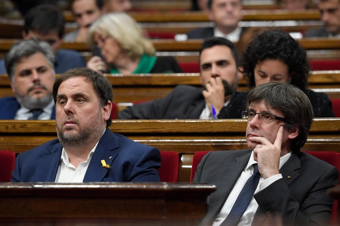 Above, Catalan regional leaders Carles Puigdemont, right, and Oriol Junqueras attend a session at Catalan parliament in Barcelona on October 26. Opposition leaders have called on Puigdemont to find a solution to the standoff with Madrid. (AFP)
