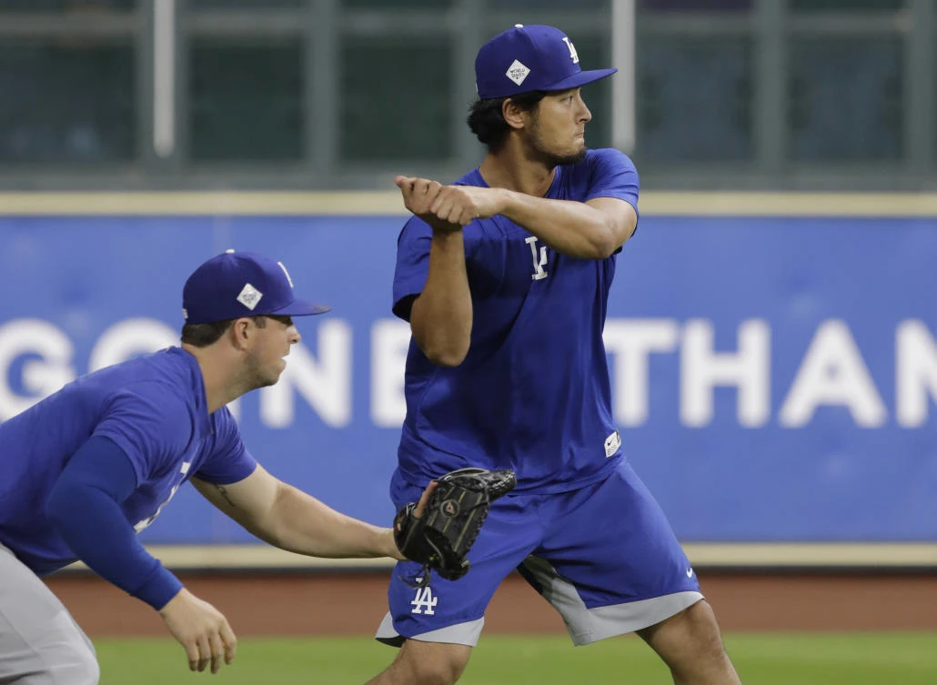 Los Angeles Dodgers’ Yu Darvish, right, takes a batting stance during a practice for a World Series baseball game, Thursday, Oct. 26, 2017, in Houston, Texas. (AP/Eric Gay)