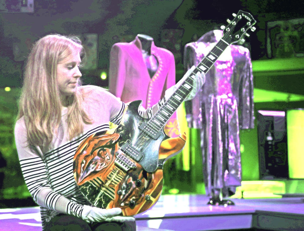 An employee shows a guitar once used by artist Prince, at the 'My Name is Prince' exhibition at the O2 Arena in London, on Thursday. (AP)