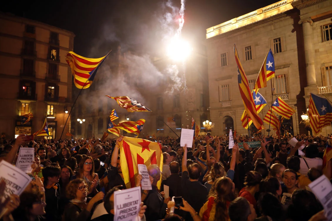 Pro-independence supporters outside the Palau Generalitat in Barcelona celebrate on Friday after Catalonia’s regional parliament passed a motion with which they say they are establishing an independent Catalan Republic. (AP)