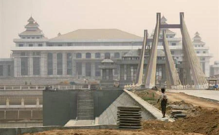 A worker walks in front of the parliament building under construction in Myanmar’s new capital of Naypyitaw on March 26, 2010. (File photo by Reuters)