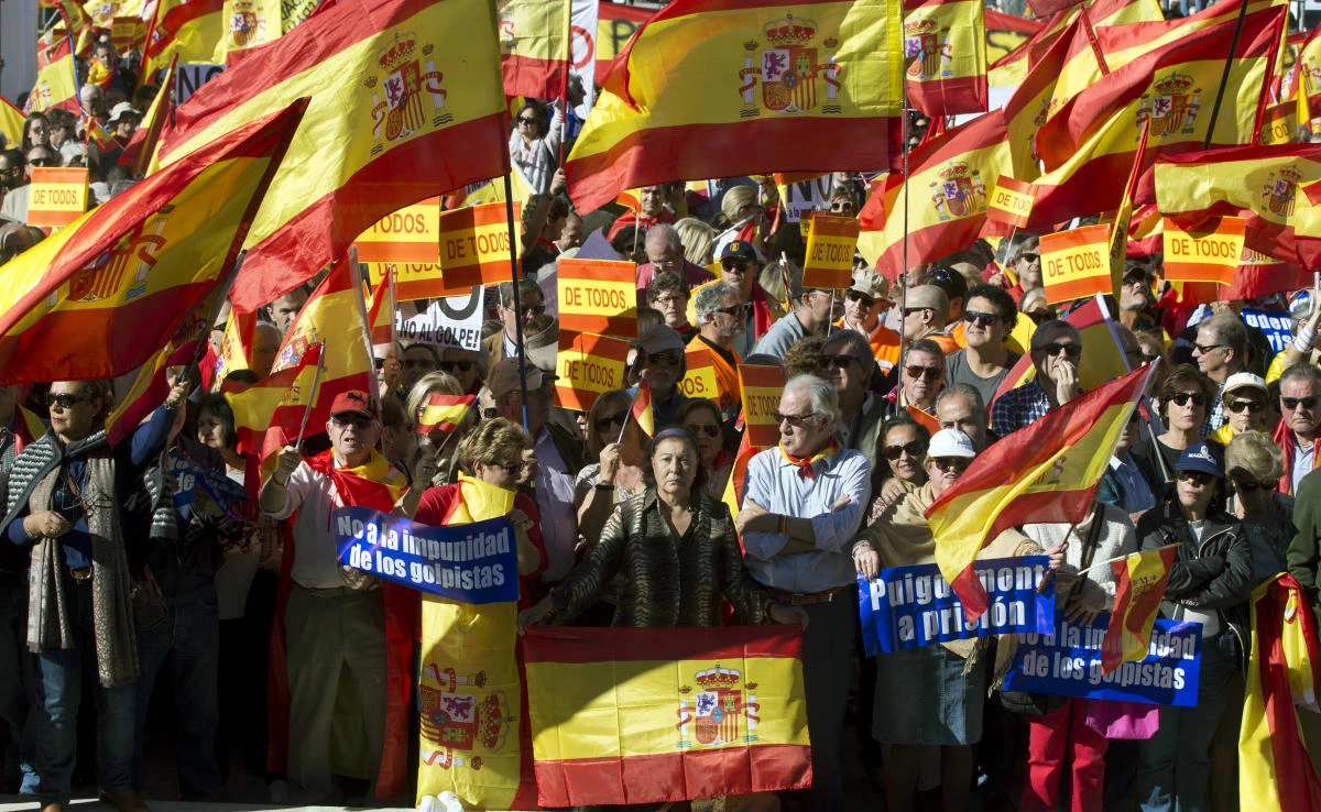 People wave Spanish flags during a mass protest by people angry with Catalonia’s declaration of independence, in Madrid, Spain on Saturday, October 28, 2017. (AP)