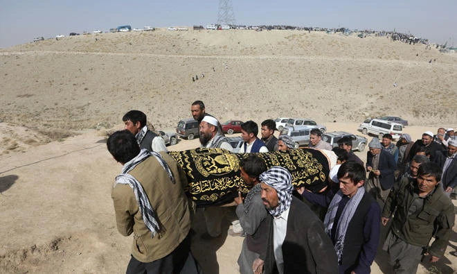 Afghan men carry the coffin of a victim who was killed in last night's suicide attack at the Shiite mosque in Kabul in this Aug. 26, 2017 file photo. (AP Photo/Rahmat Gul)
