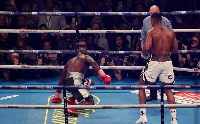 Carlos Takam staggers after being knocked down by Anthony Joshua in their heavyweight match on Saturday at the Principality Stadium in Cardiff, Britain. (Action Images via Reuters/Peter Cziborra)