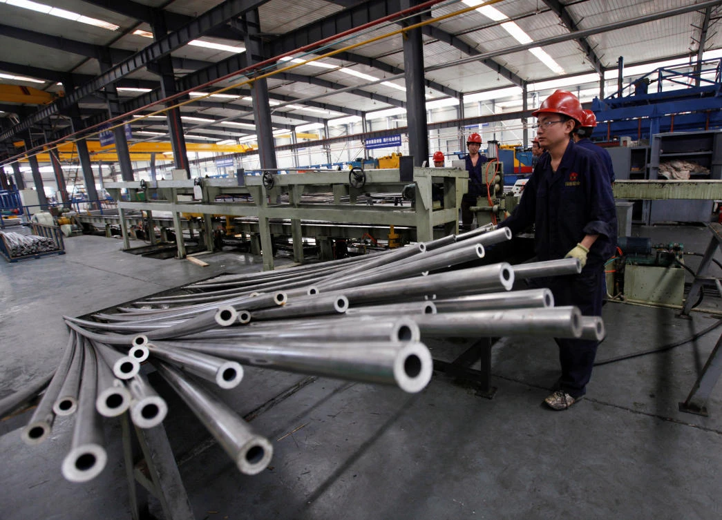 Above, workers at the Qinghai Guoxin Aluminium Industry Incorporated Company workshop in Qinghai province. Beijing has complained the US was still using “discriminatory” surrogate country pricing methods to put high duties on Chinese goods. (Reuters)