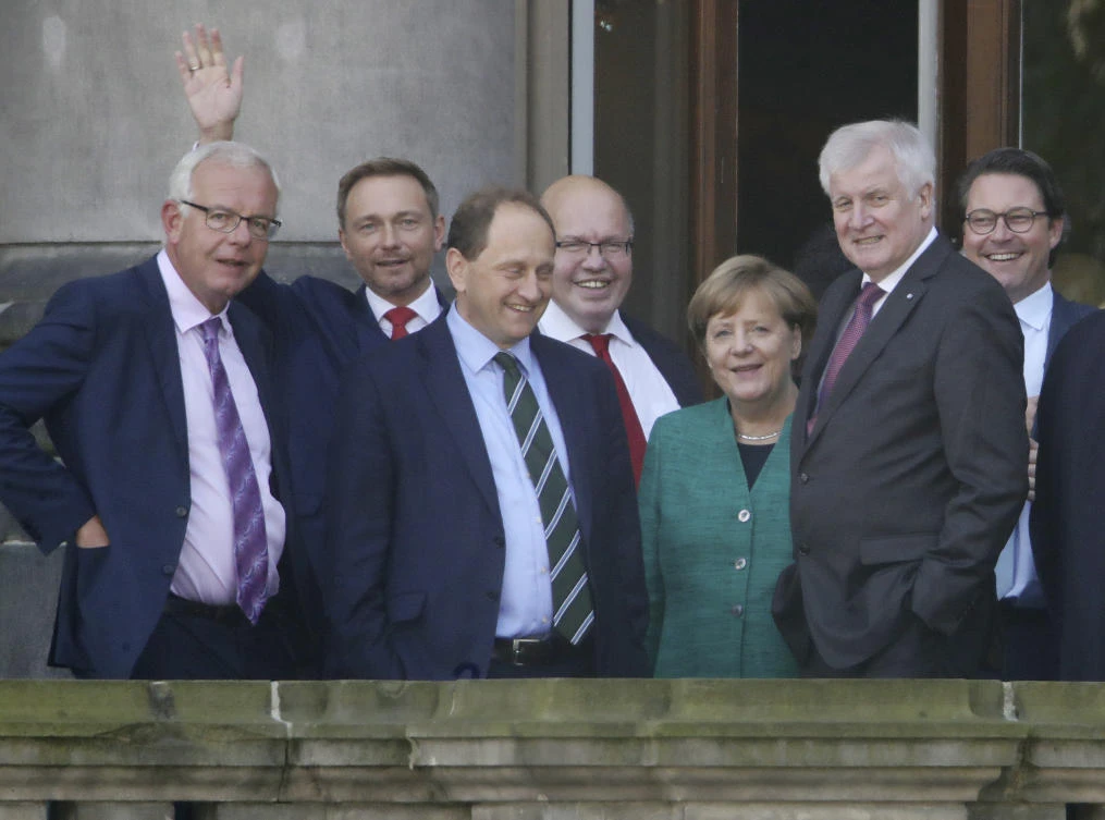 German Chancellor Angela Merkel is meeting members of three smaller political parties to sound out their red lines. (Michael Kappeler/dpa via AP)