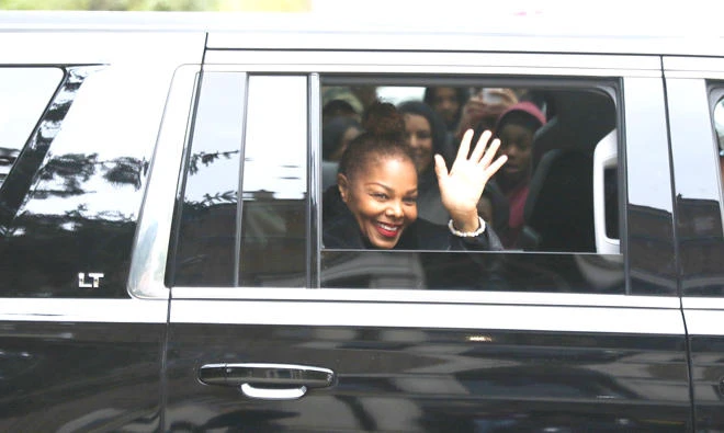 Janet Jackson waves goodbye as she leaves the former Roosevelt High School in Gary, Ind., Saturday. (AP)