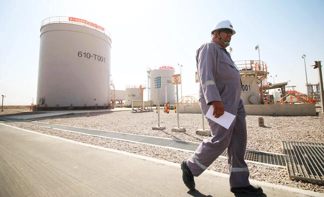 A photo taken on October 23, 2017 shows an employee walking at the Rumaila natural gas powerstation, north of the southern Iraqi port of Basra. (AFP)